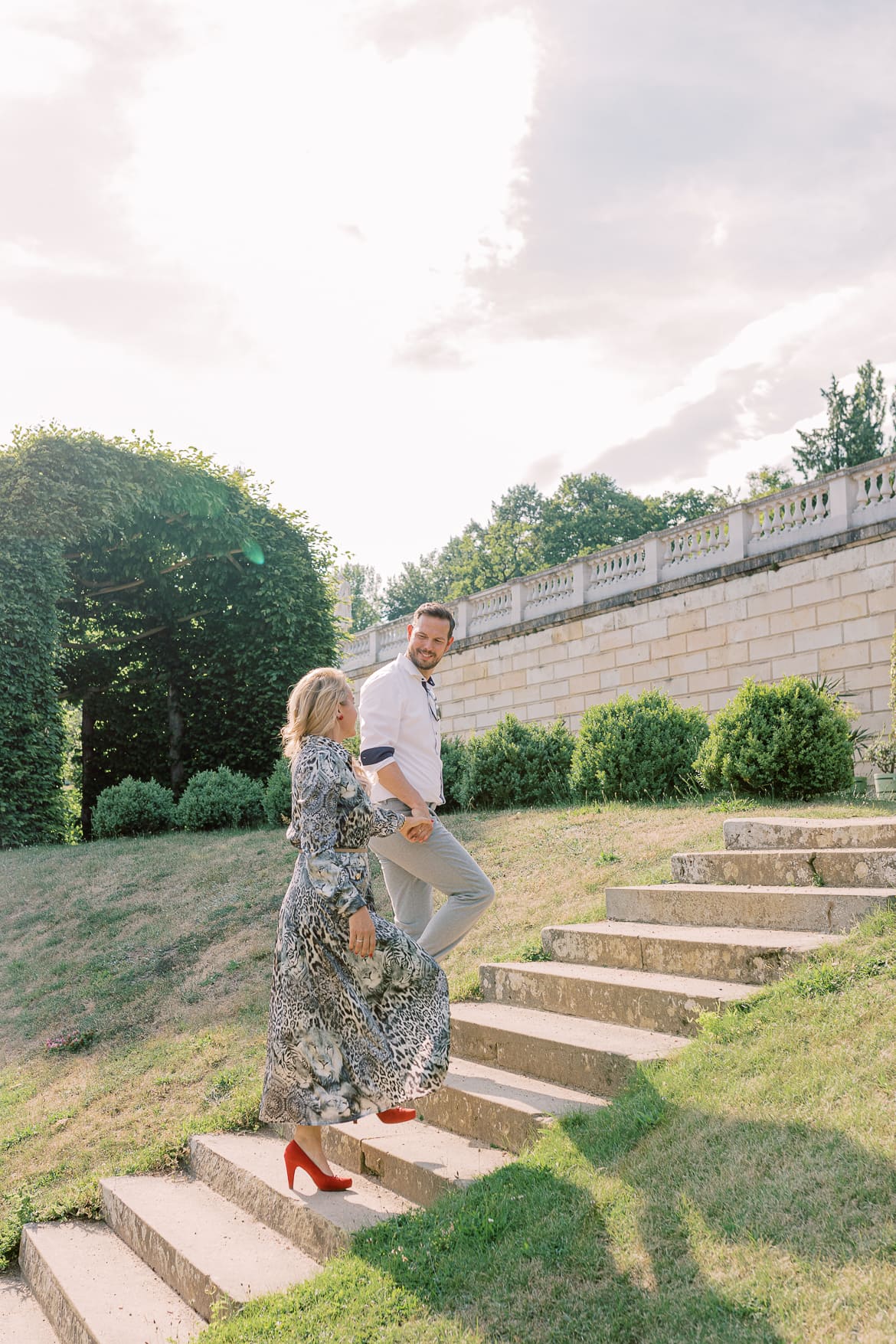 Mann führt seine Frau eine Treppe hinauf