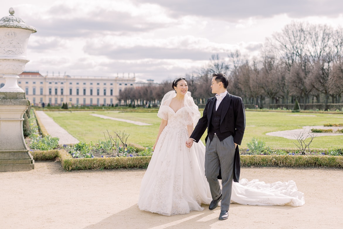 Hochzeitspaar spaziert durch einen Park