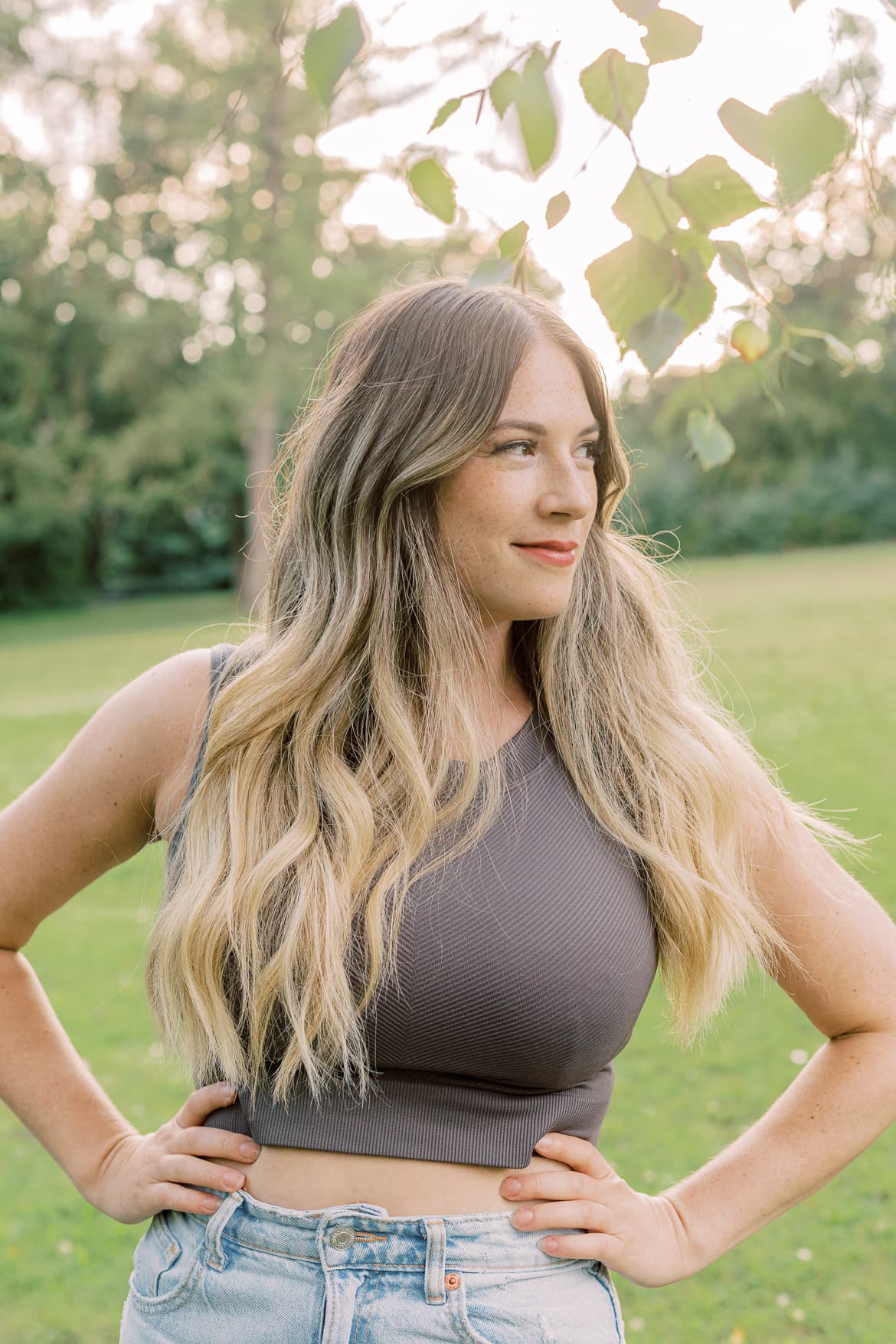 Frau mit blonden Haaren in der Abendsonne im Park