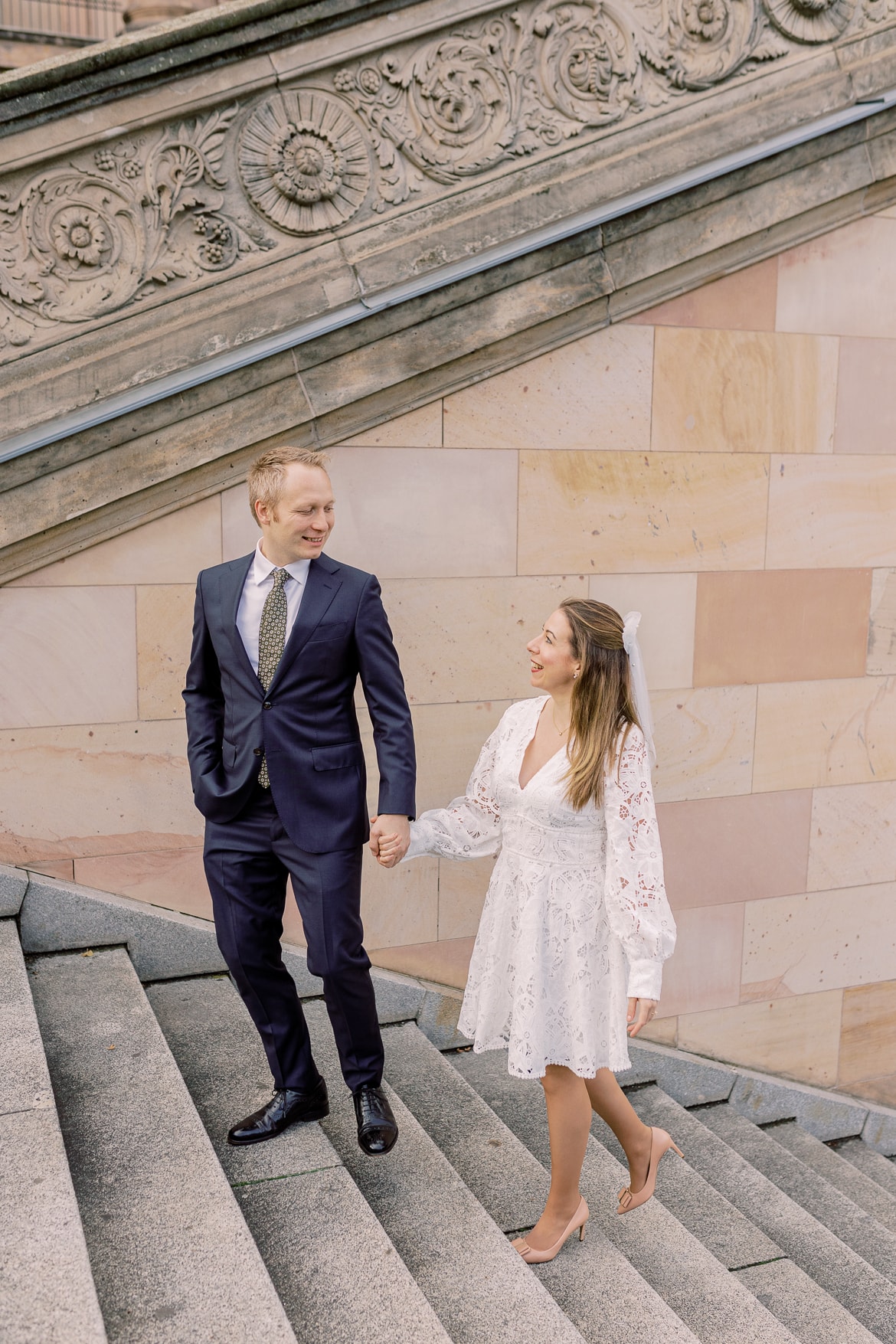 Paar geht lächelnd eine Treppe hinauf